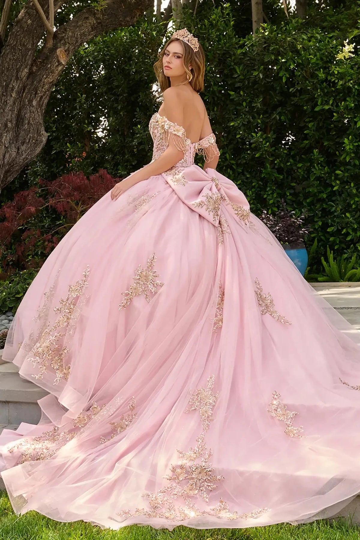 Blush quinceañera ball gown completed with detachable bow at back for refined and elegant finish