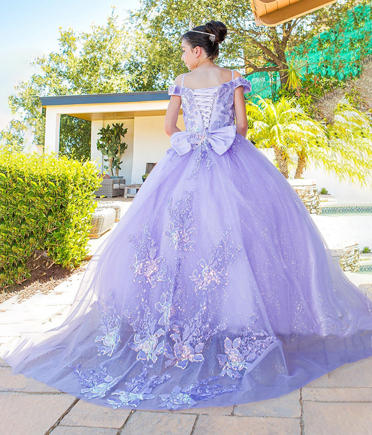 girl in a lilac ball gown with floral embroidery standing outdoors.