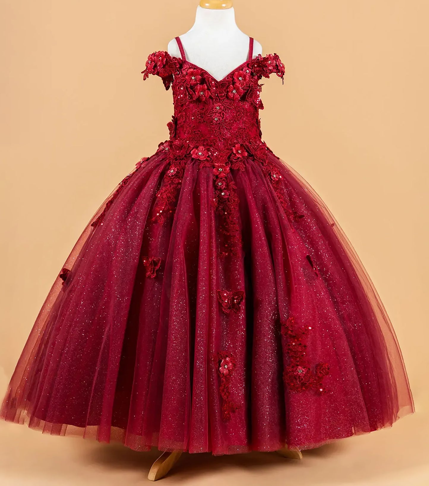 Red floral dress on a mannequin against a beige background