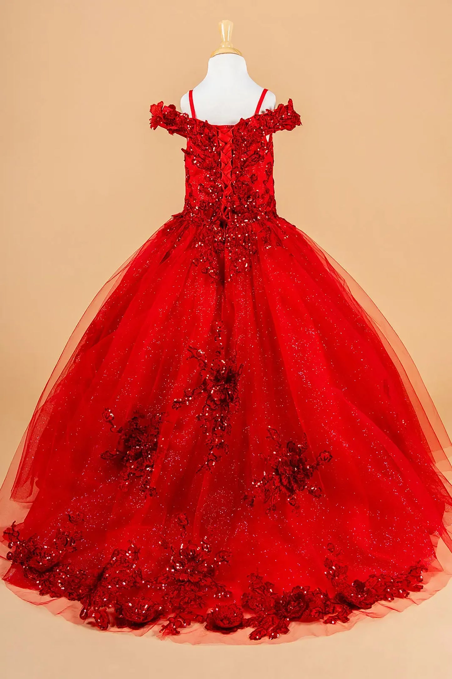 Red ball gown with floral details on a beige background