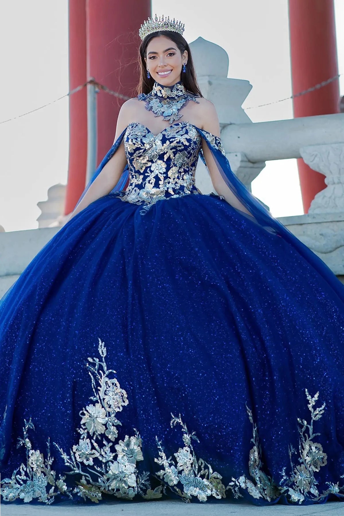 Full-length view highlights navy quinceanera ball gown with golden lace, detachable shoulder train sleeves, and floral embroidery.