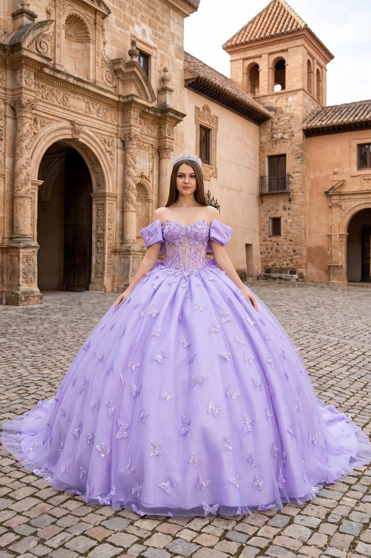 Woman in a lilac quinceanera ball gown with 3D butterflies standing in front of a historic building.