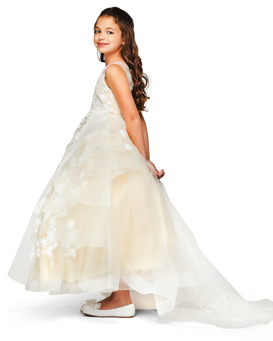 Young girl wearing a Champagne floral dress on a white background