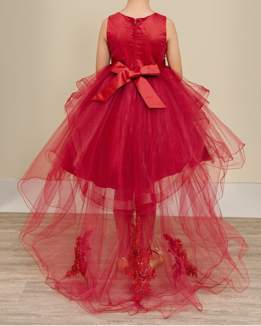 burgundy dress with a large bow on a neutral background