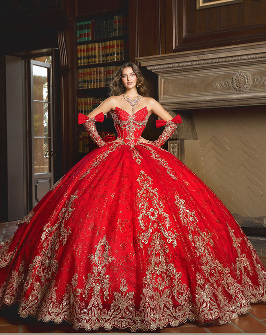 Girl in a red and gold embroidered quinceañera ball gown standing in a room with a fireplace.