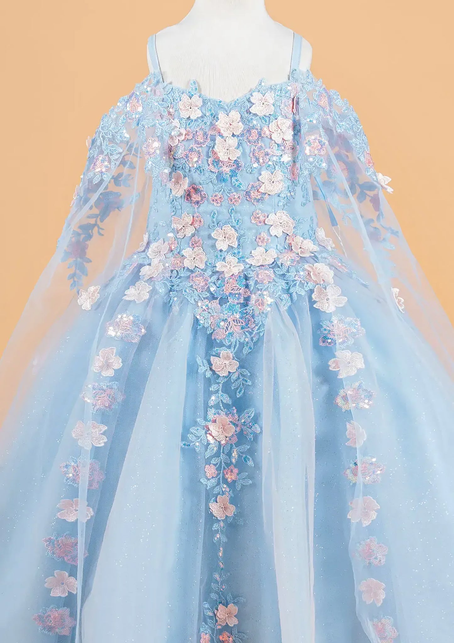 Light blue dress with floral embroidery on a beige background