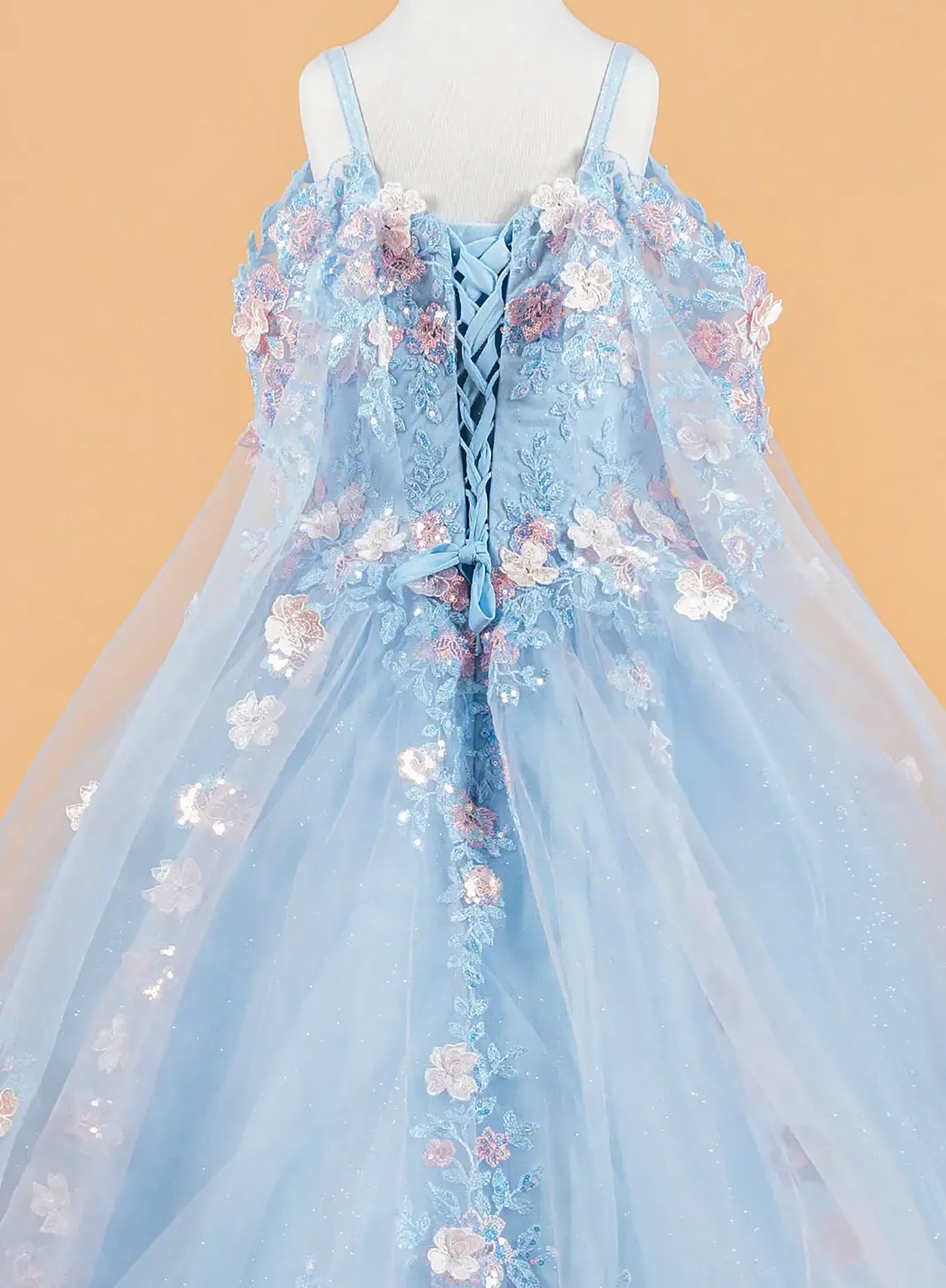 blue dress with floral embroidery on a beige background