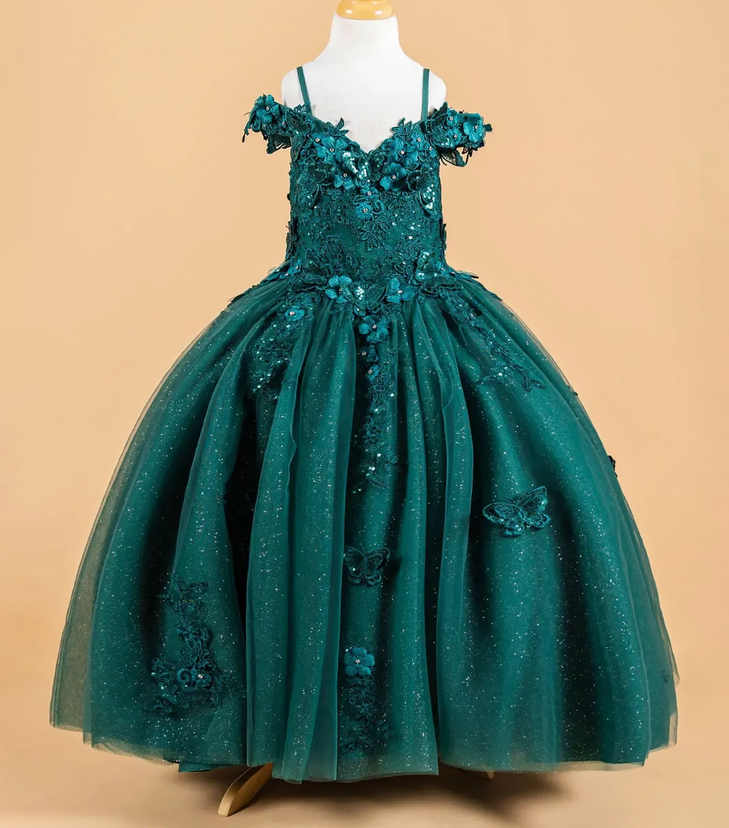 Green floral dress on a mannequin against a beige background