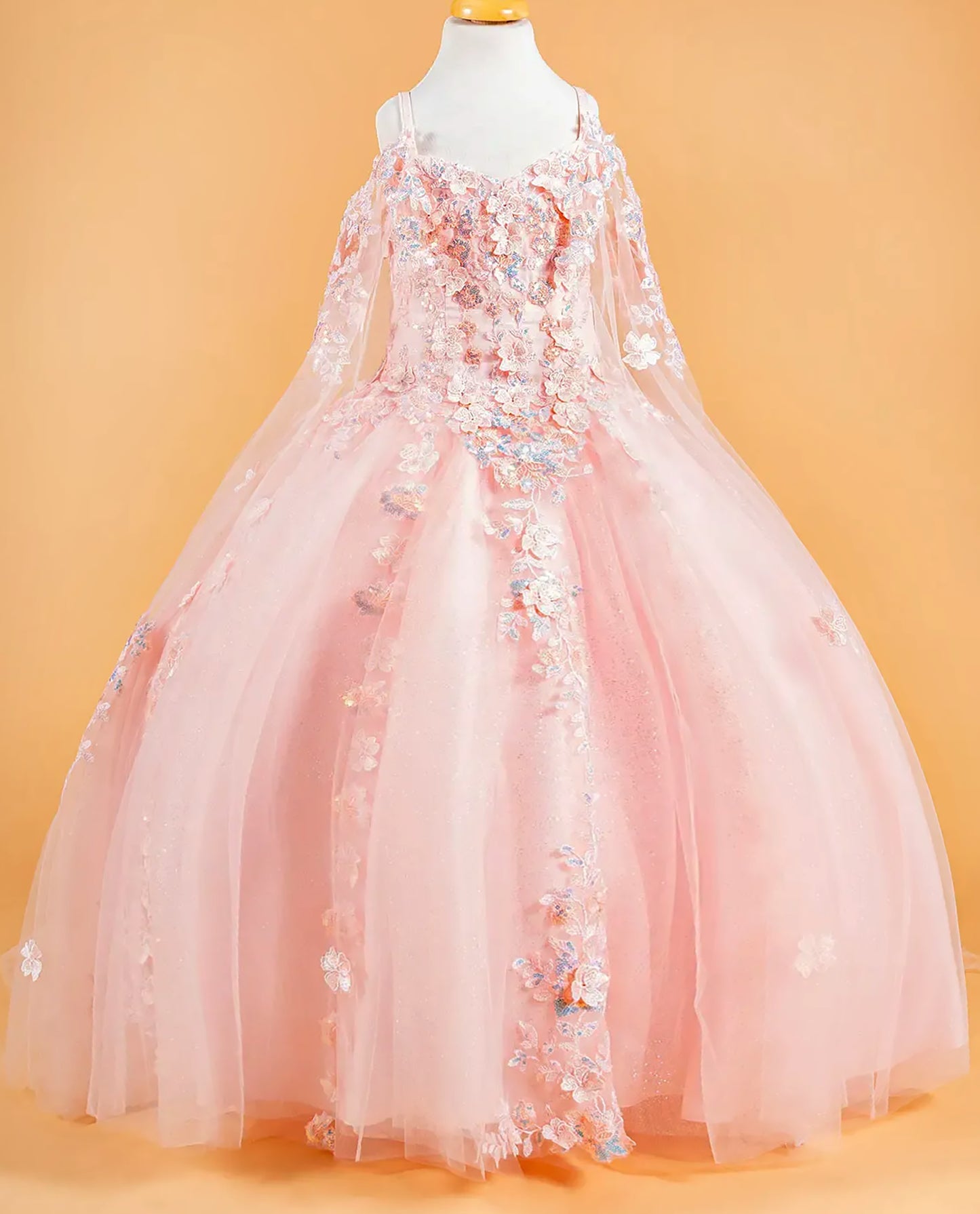 blush floral dress on a mannequin against an orange background