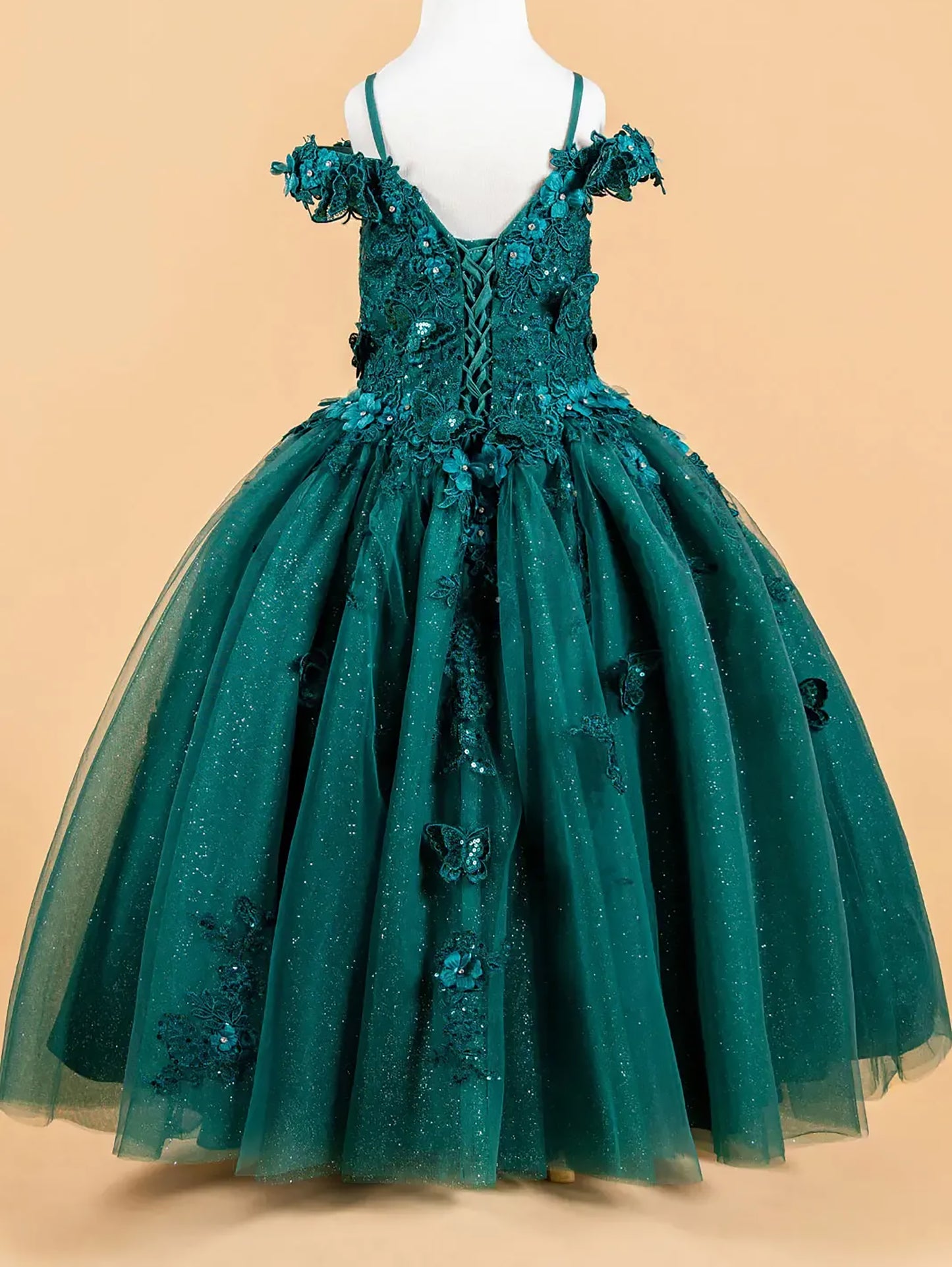 Green sequin dress on a mannequin against a beige background