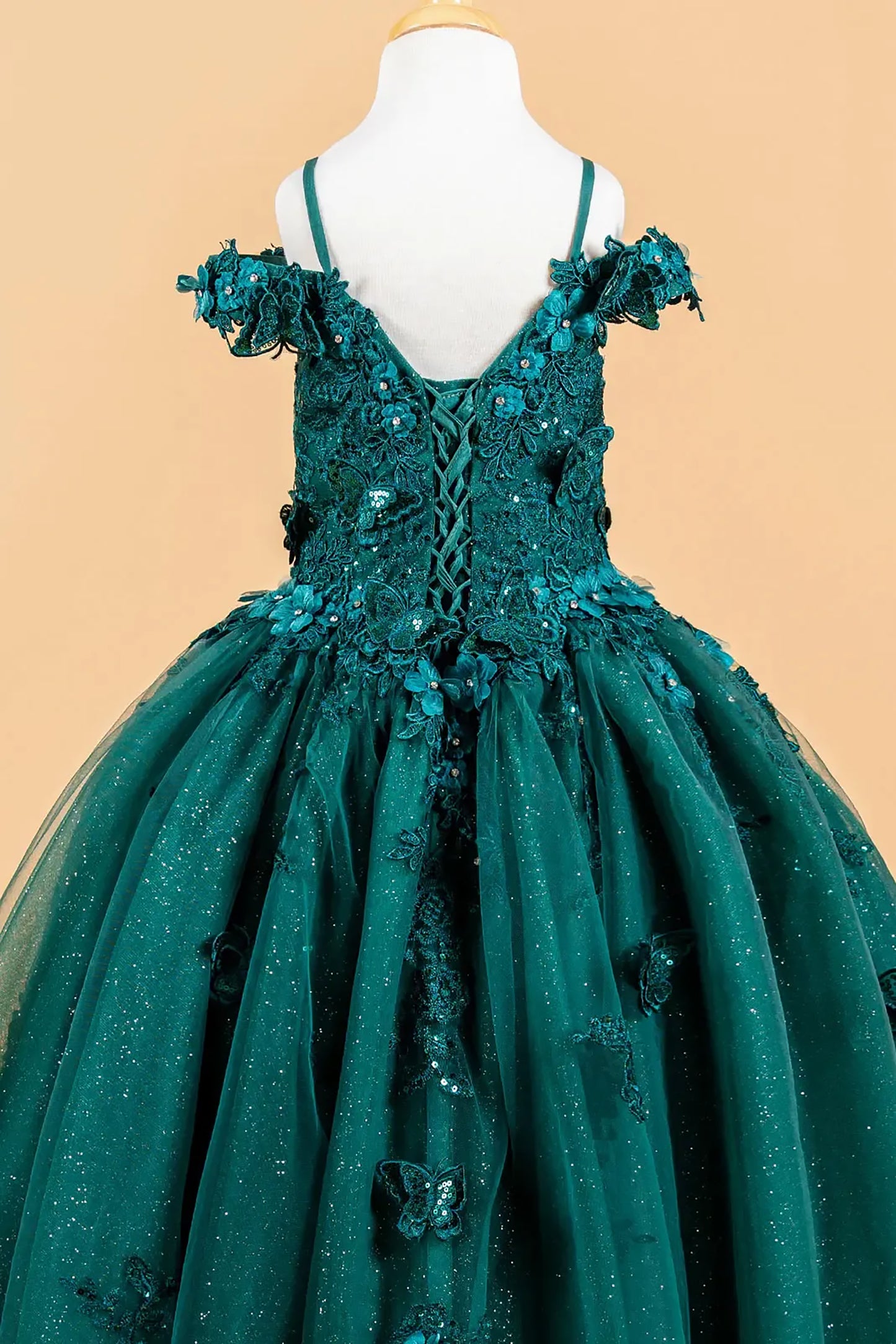 Green evening gown with floral details on a beige background