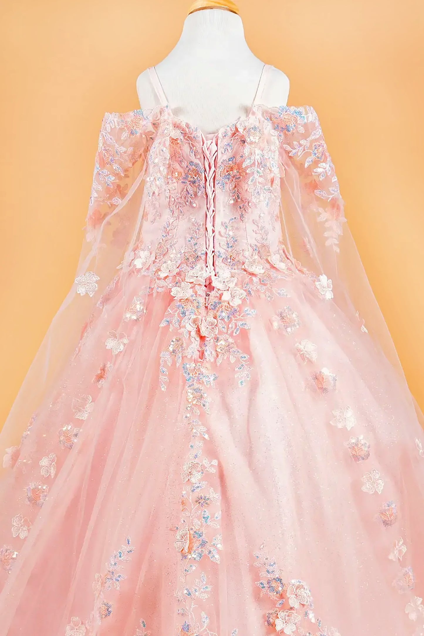 floral kid dress on a mannequin against an orange background