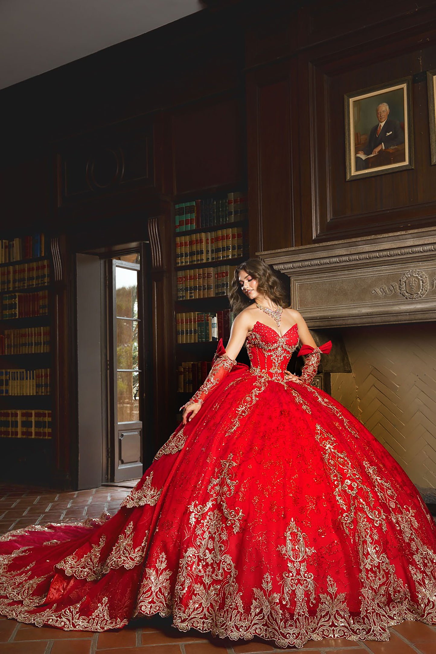 Woman in a red and gold gown standing in a room with wooden paneling and books.