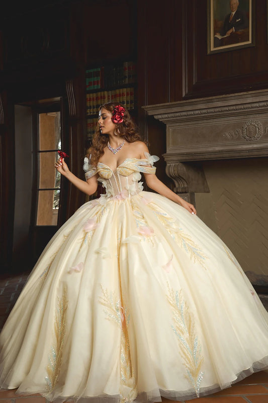 Woman in a white ball gown with floral decorations in an elegant interior setting.