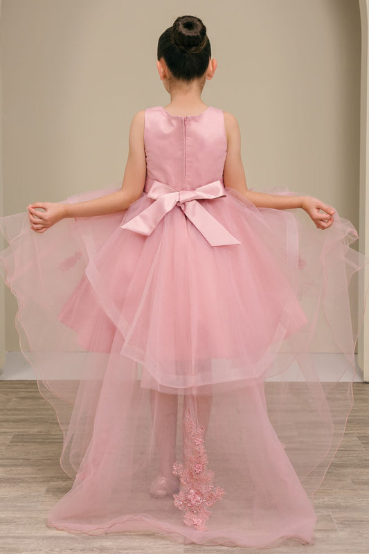 dusty rose high low dress with a bow and floral details on a plain background