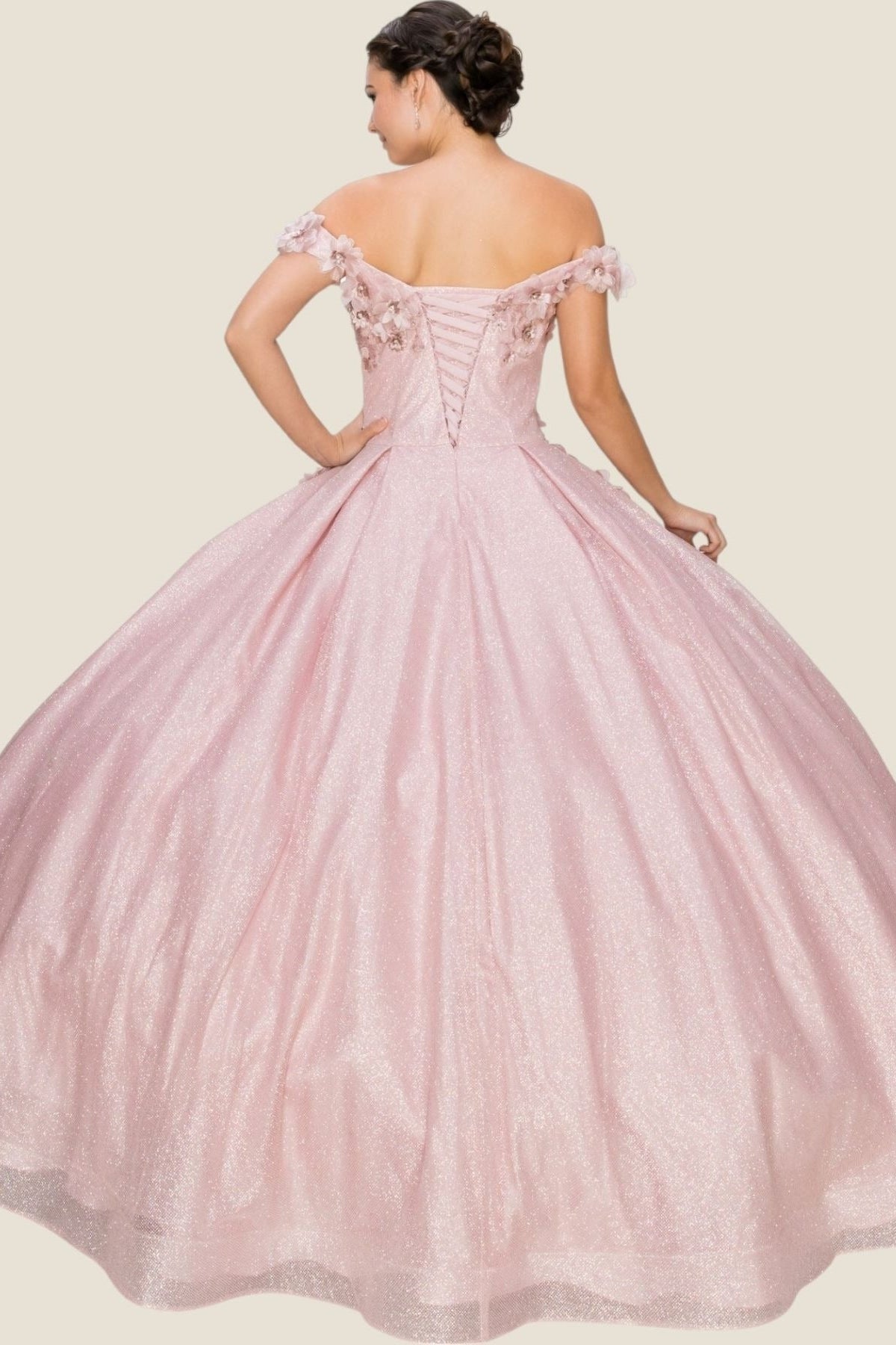Rear view reveals Dusty Rose quinceanera dress with off-shoulder floral appliques, glitter details, and pleated beaded skirt.