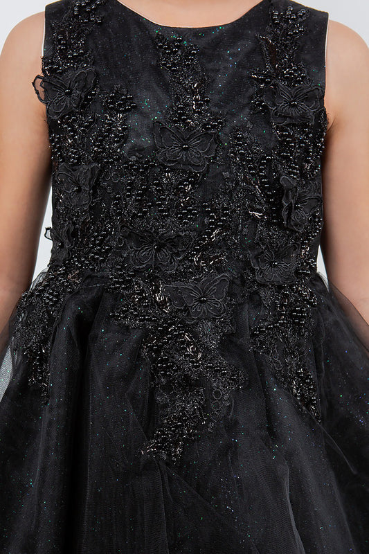 Black dress with floral and butterfly patterns on a plain background