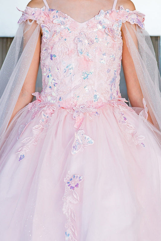 Pink floral dress with a tulle overlay on a plain background