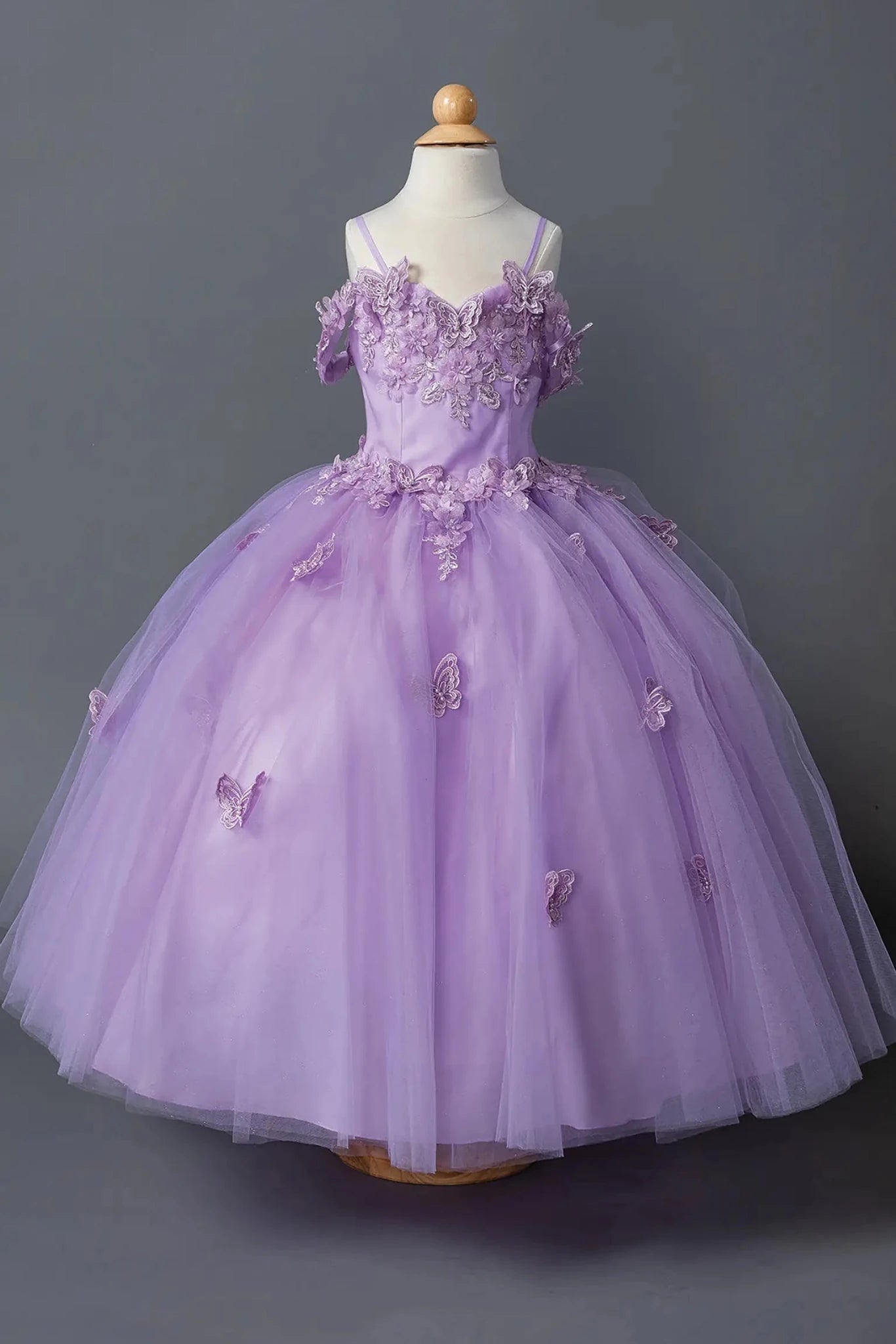 Lilac kids mini quinceañera mini quince dress with lace-up bodice, floral appliqué detailing, and glitter tulle skirt.