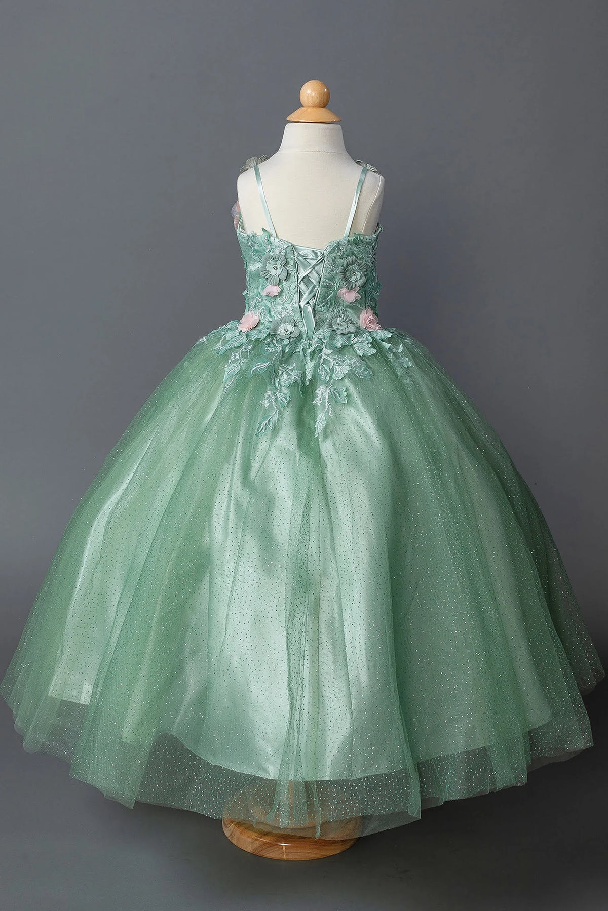 At the back, the Sage mini quinceañera dress features lace-up back surrounded by dimensional flowers.