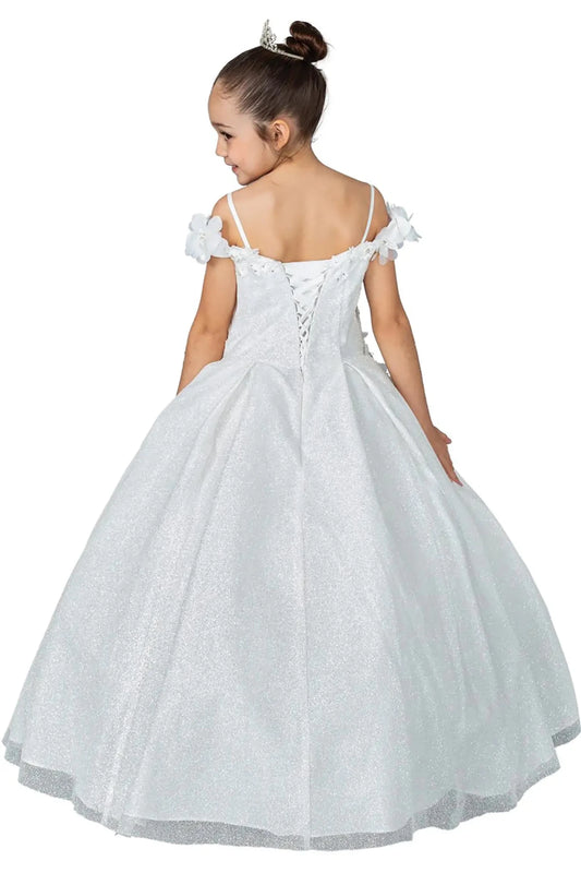 Young girl standing back-facing in white kids mini quinceañera dress with lace-up bodice, floral shoulder appliqués, and glitter tulle skirt