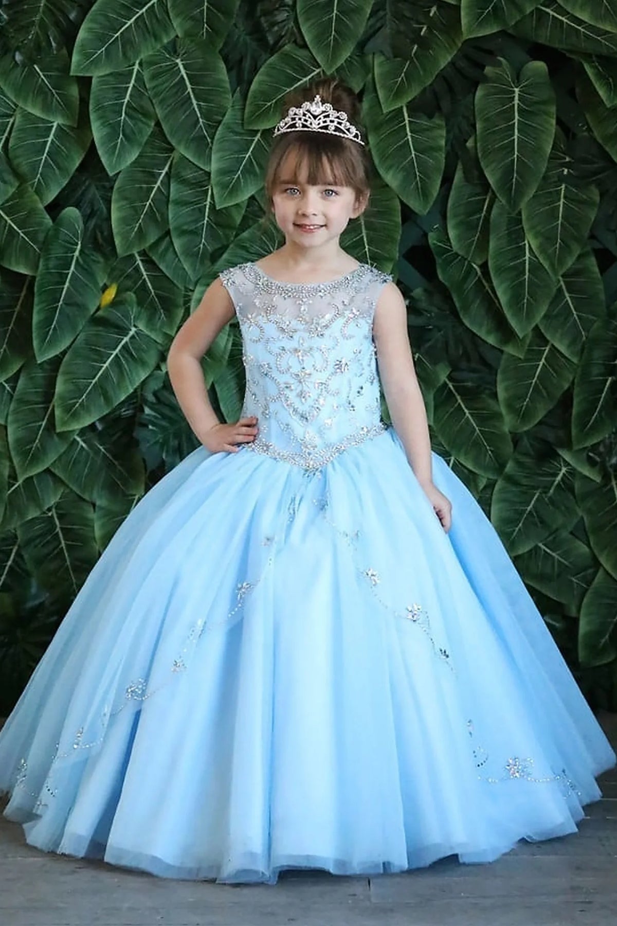 An alternate angle captures full tulle ball gown skirt with appliqué accents on the Bahama Blue mini quince dress.