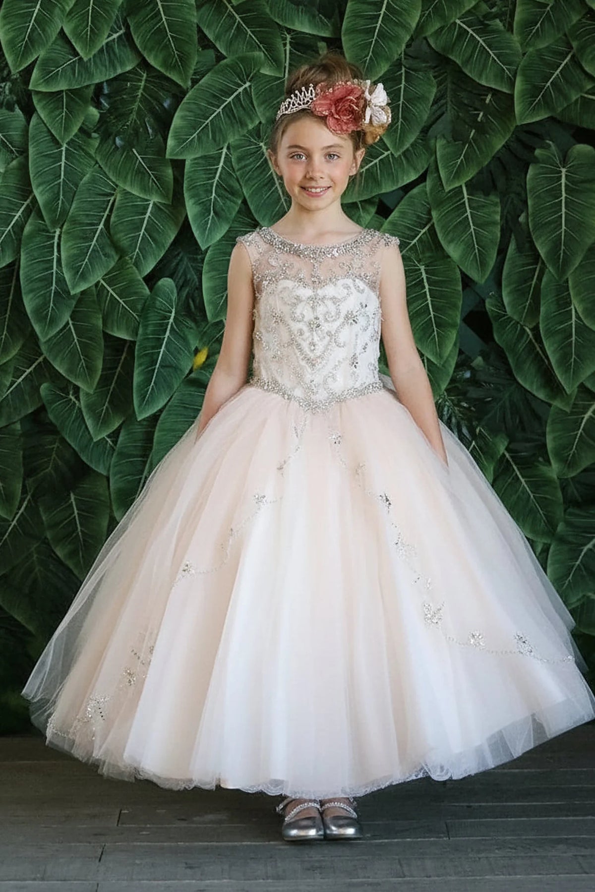 A closer look shows, the Champagne mini quince dress showcases floral embroidered fitted bodice and full tulle ball gown skirt with appliqué accents.
