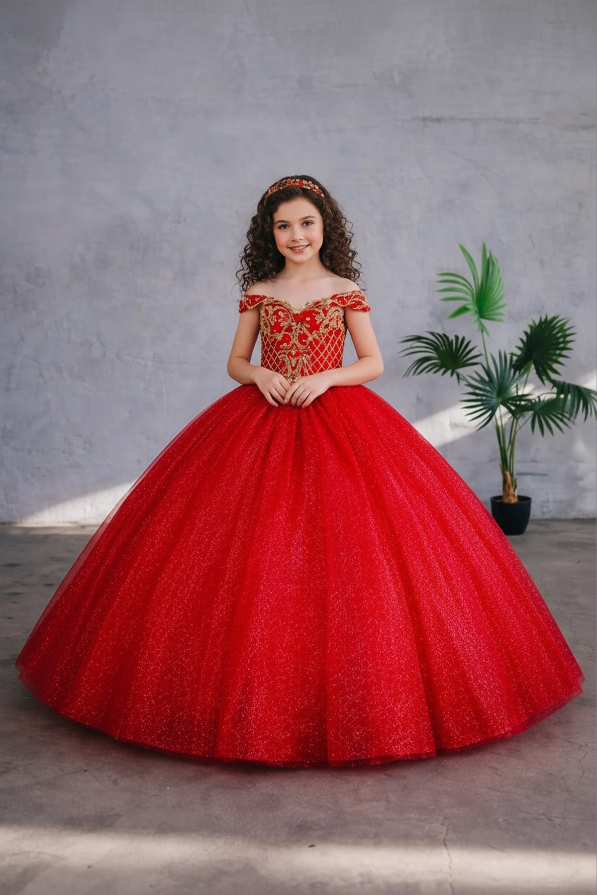 Seen at full length, the Red/Gold mini quince dress showcases metallic embroidered off-the-shoulder bodice and full tulle skirt with coordinating two-tone detail.