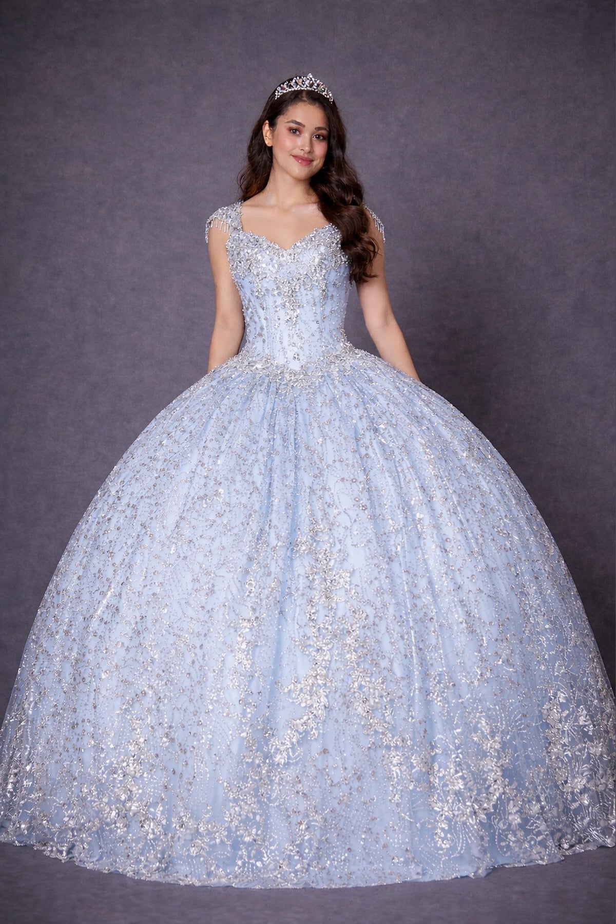 Bahama Blue quinceañera dress showcases metallic embroidered scrollwork above sparkling full ball gown silhouette.