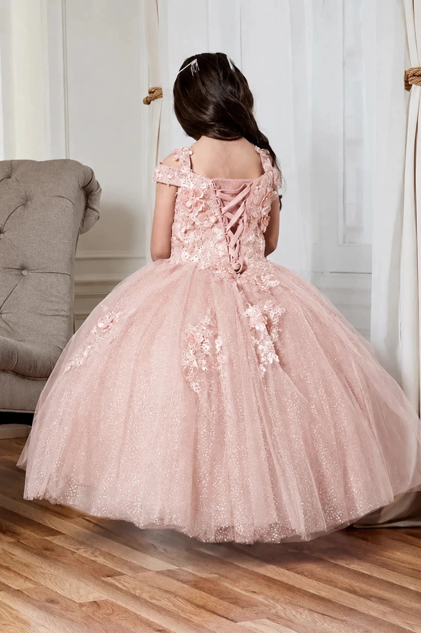 a voluminous light pink mini quince pageant ball gown with floral applique and lace-up back details,