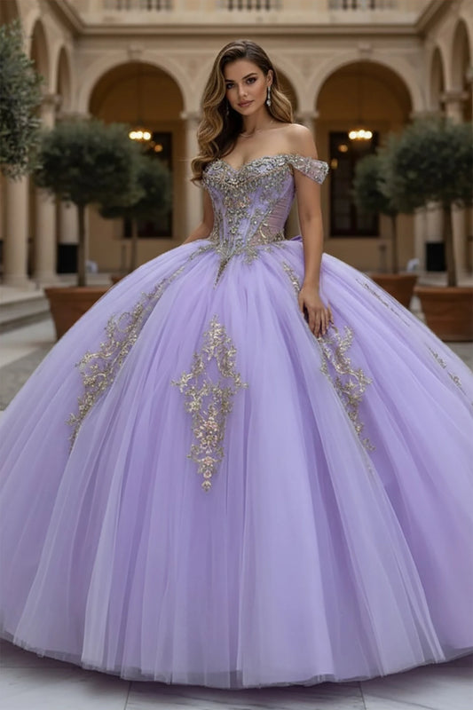 Woman wearing a lilac off the shoulder ball gown with gold embellishments in an elegant indoor setting.