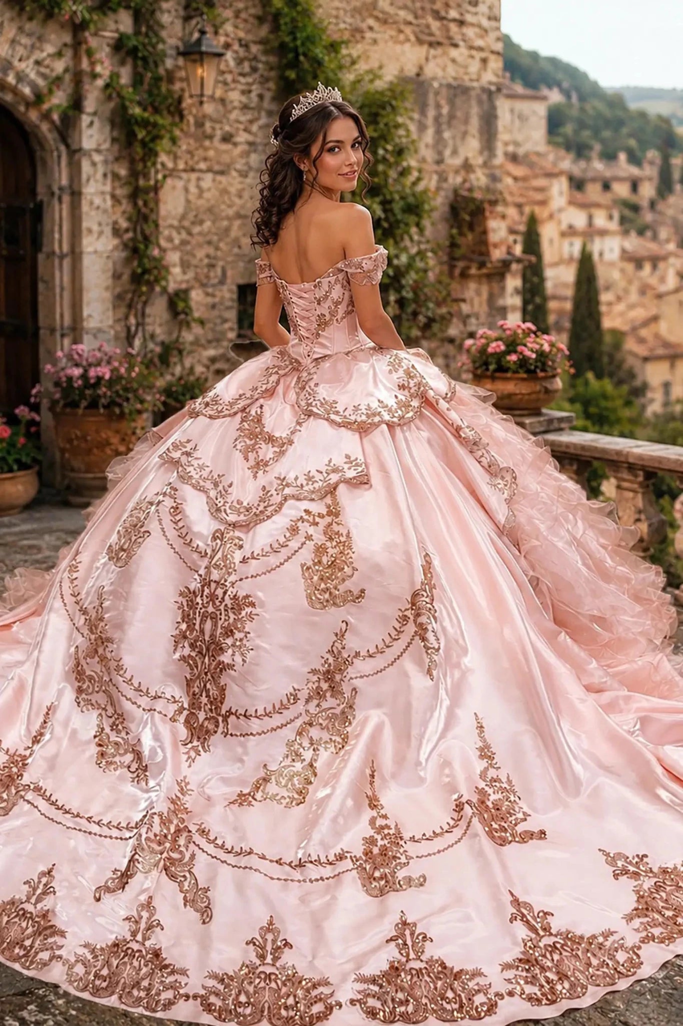 Blush quinceanera dress with lace-up corset, rose-gold embroidery, tiered overskirts, and chapel-length train