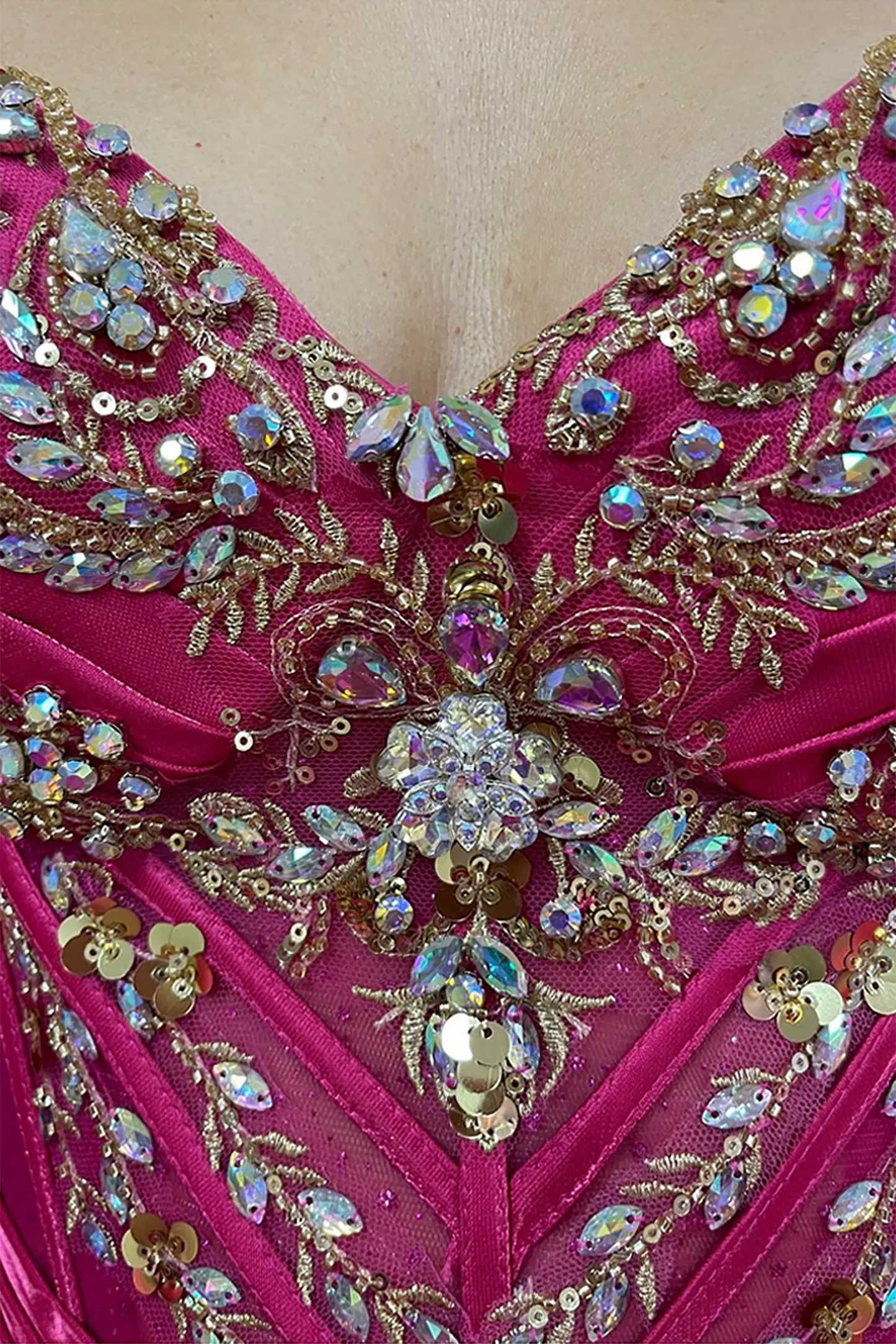 Fuchsia quinceanera ball gown showing crystal beading, rhinestones and gold embroidery