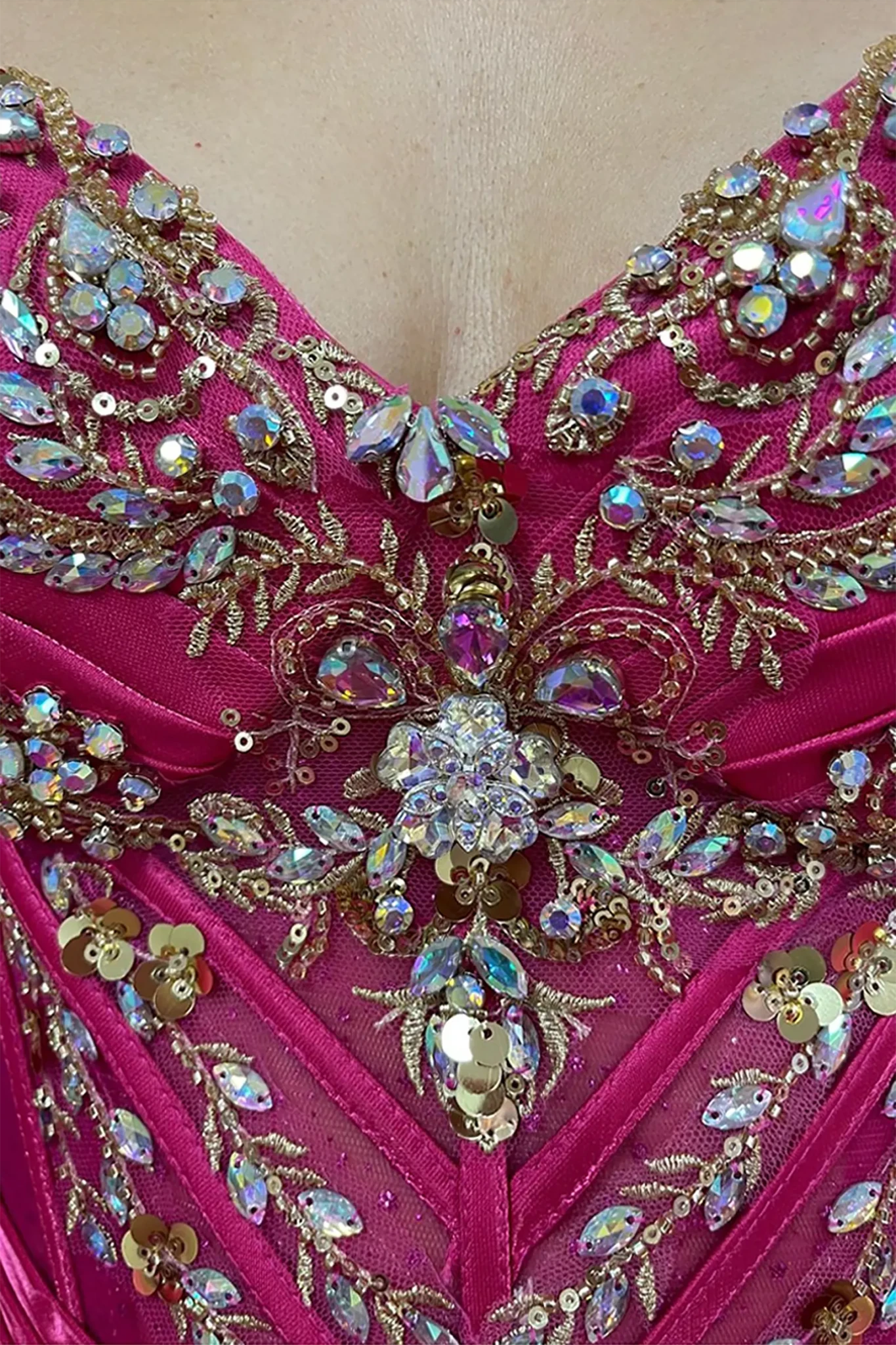 Fuchsia quinceanera ball gown showing crystal beading, rhinestones and gold embroidery