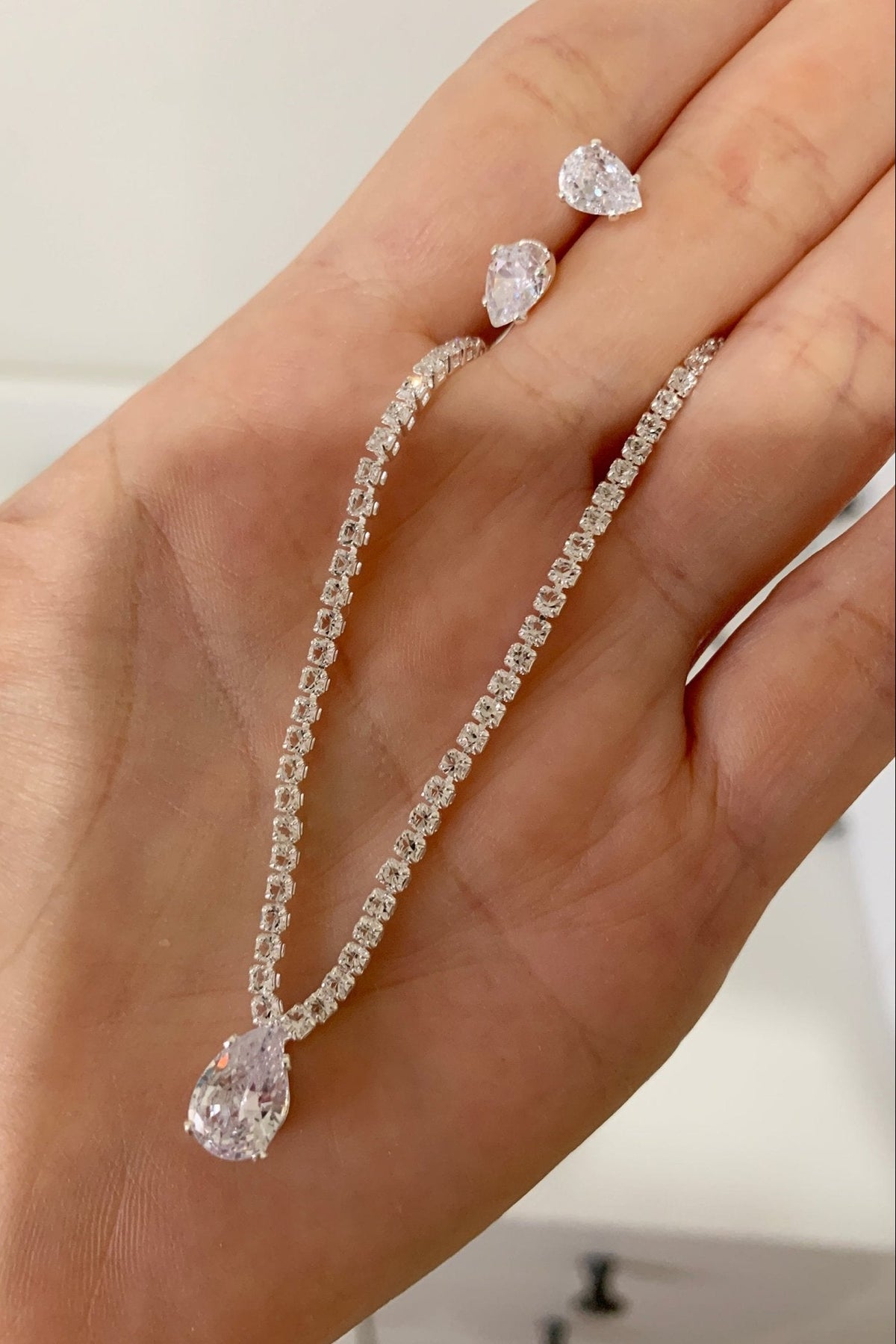 Intricate features stand out across silver rhinestone bridal, 3-Piece Dewdrop quinceañera and everyday women's necklace.