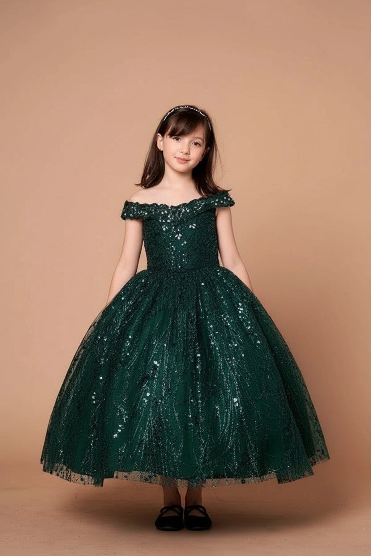 From the neckline down, the Emerald mini quince dress showcases off-the-shoulder bodice with allover sequins and glitter and matching cape over a full sparkling skirt.