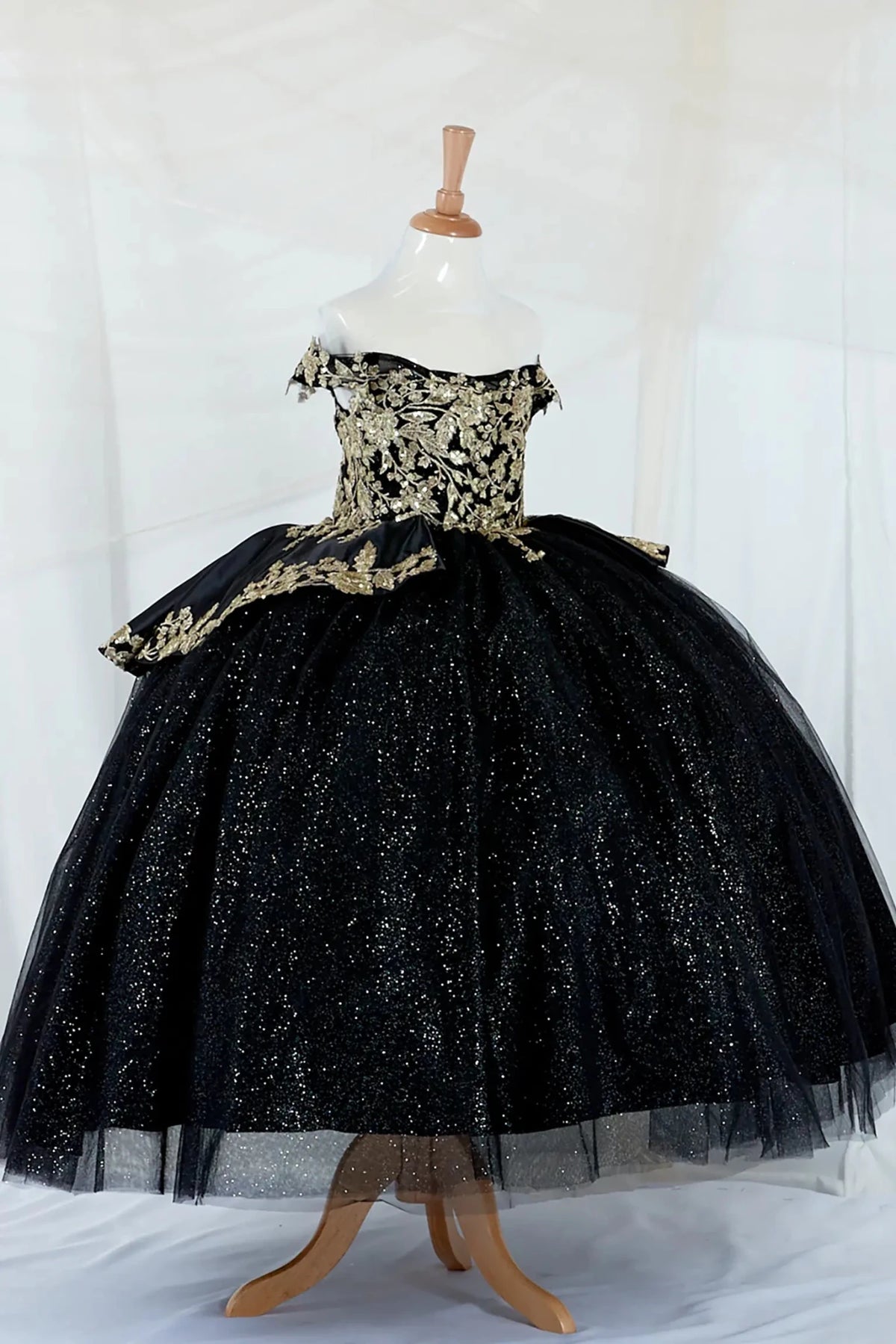 Front view of Black Kids Dress with Gold Embroidery, Beaded and Layered Glitter Skirt, Mini Quince Dress.