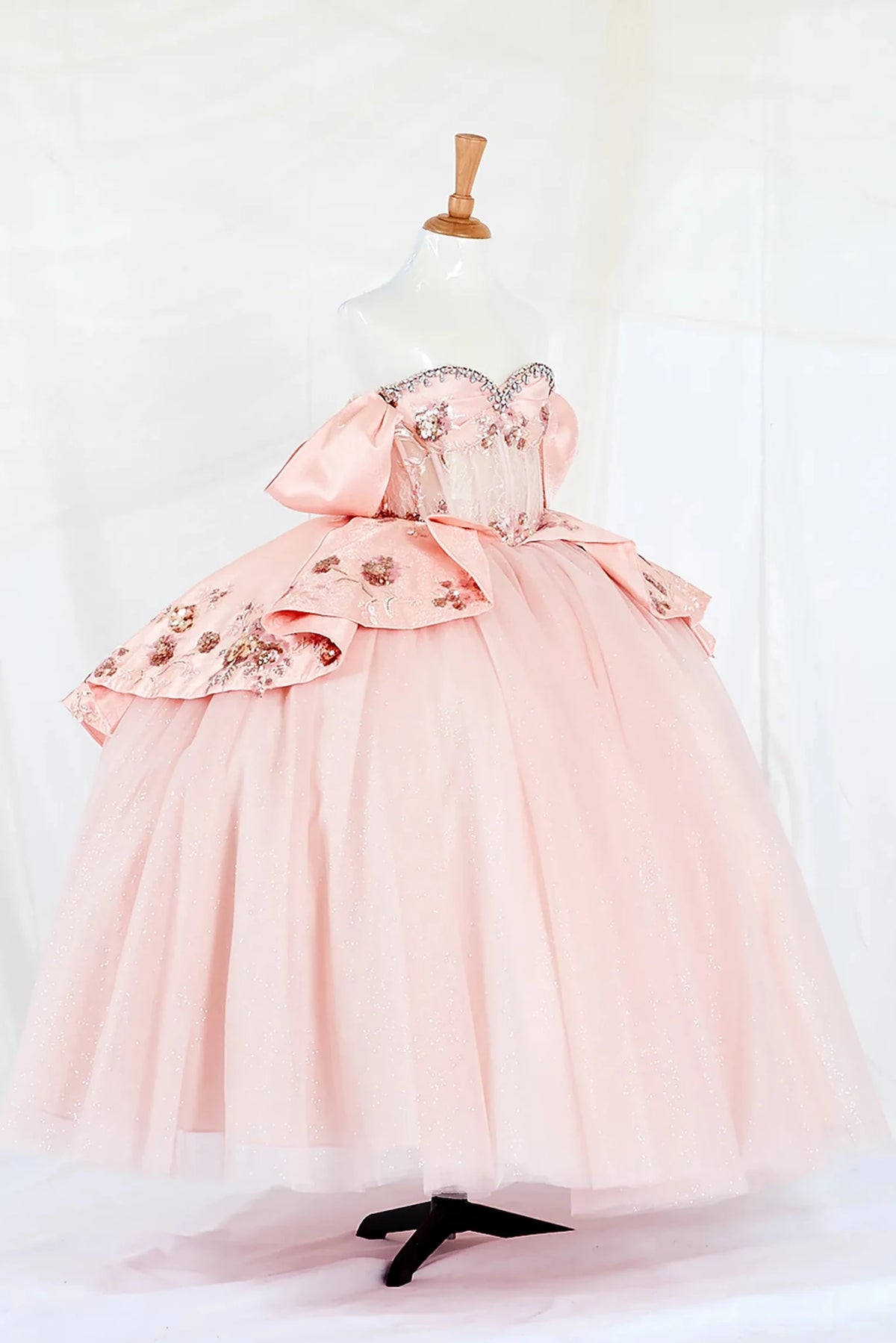 Side-facing display of a stunning lilac mini quince dress featuring a 3D floral appliqué bodice with beaded fringe detail and a glitter tulle layered skirt.
