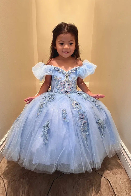 Kid standing front-facing in light blue ball gown with sheer illusion corset bodice, structured sweetheart neckline, and flowing skirt