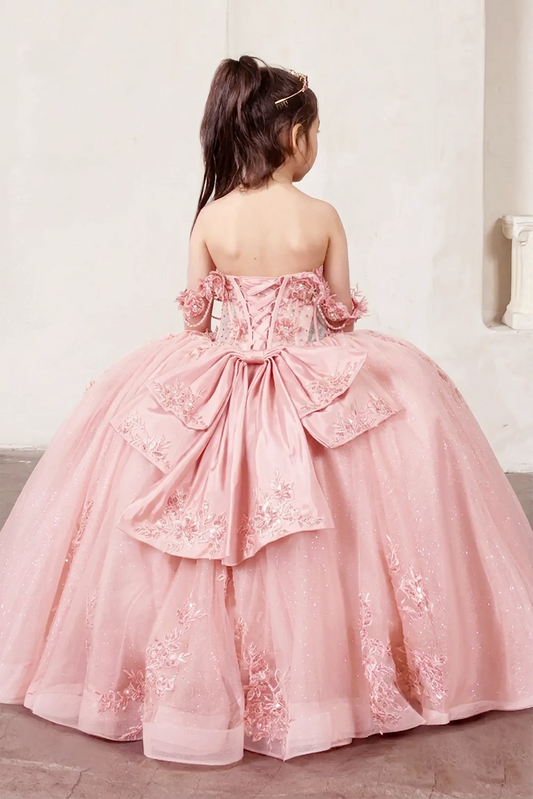 Young girl in a pink formal gown with floral details and extra large back bow