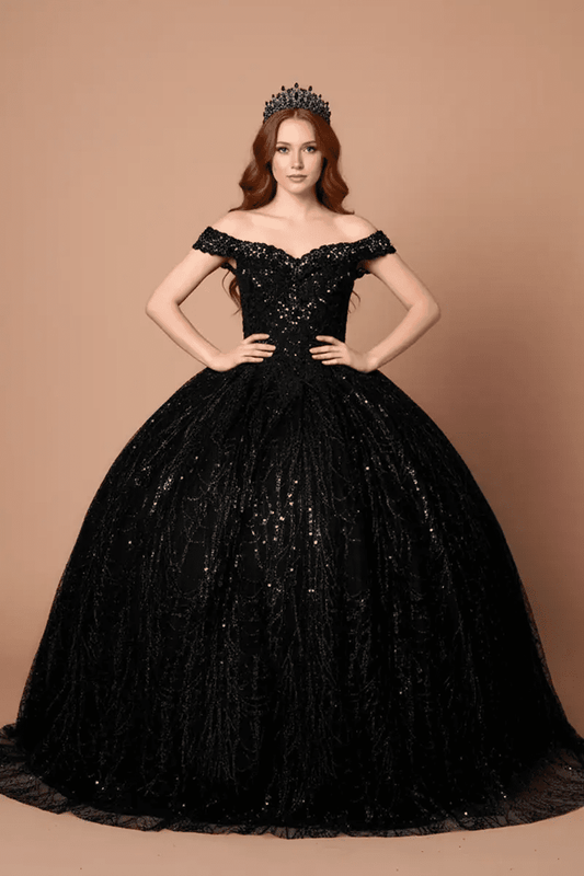 Front-Facing of a woman wearing Black formal gown featuring open back design sweeping hemline and attached cape detail
