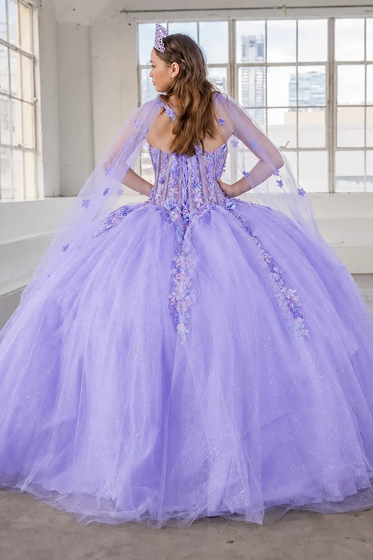 From behind, the Lilac quinceañera ball gown reveals a shaped lace-up back and the sweep of the full skirt.
