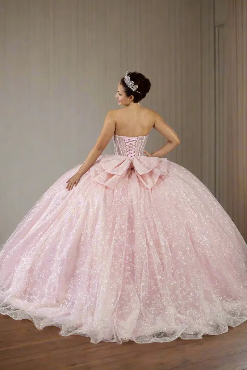 Back-Facing of a woman wearing Bubble pink formal gown featuring fitted bodice full skirt and soft flowing silhouette
