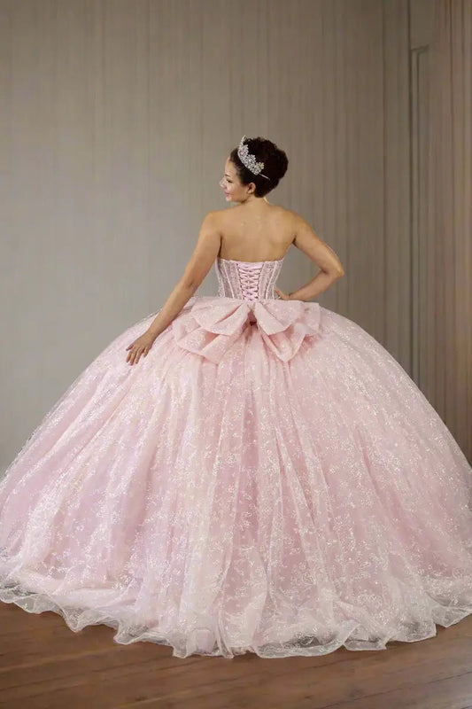Back-Facing of a woman wearing Bubble pink formal gown featuring fitted bodice full skirt and soft flowing silhouette