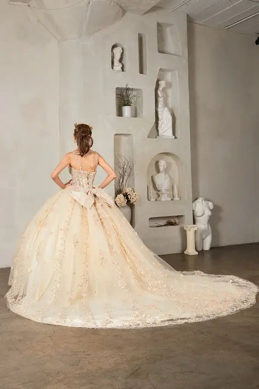 Back-Facing of a woman wearing Champagne formal gown featuring structured back layered lace skirt and flowing silhouette