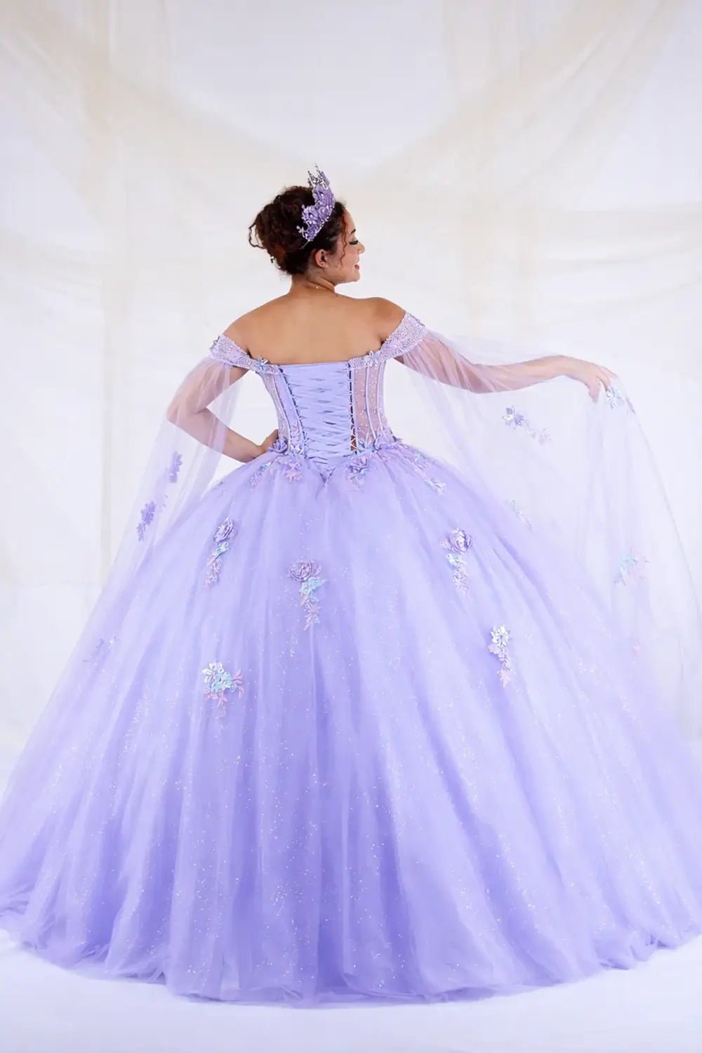Lilac quinceañera ball gown with sheer lace bodice, full skirt and detachable cape