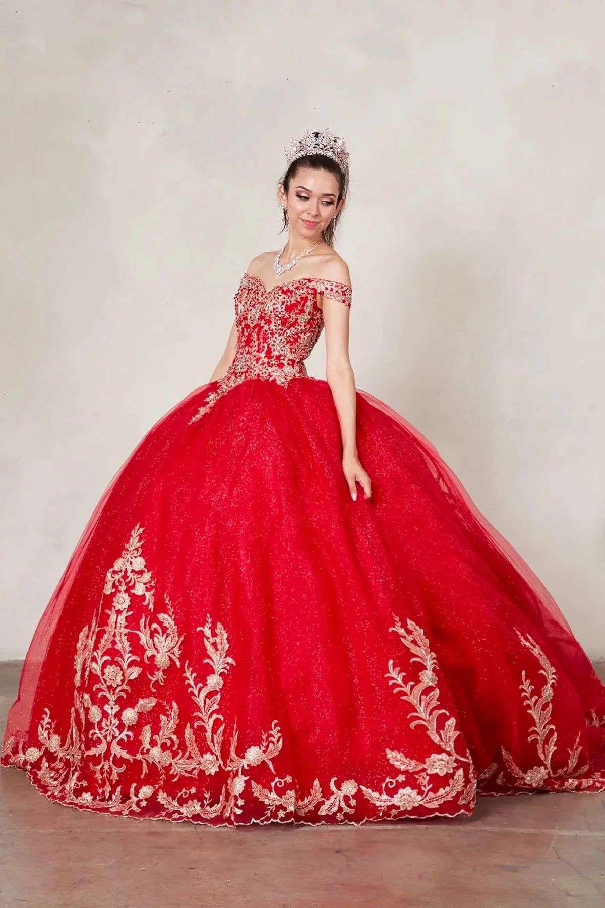 Red quinceañera ball gown with gold embroidered lace applique, glitter tulle overlay and A‑line silhouette
