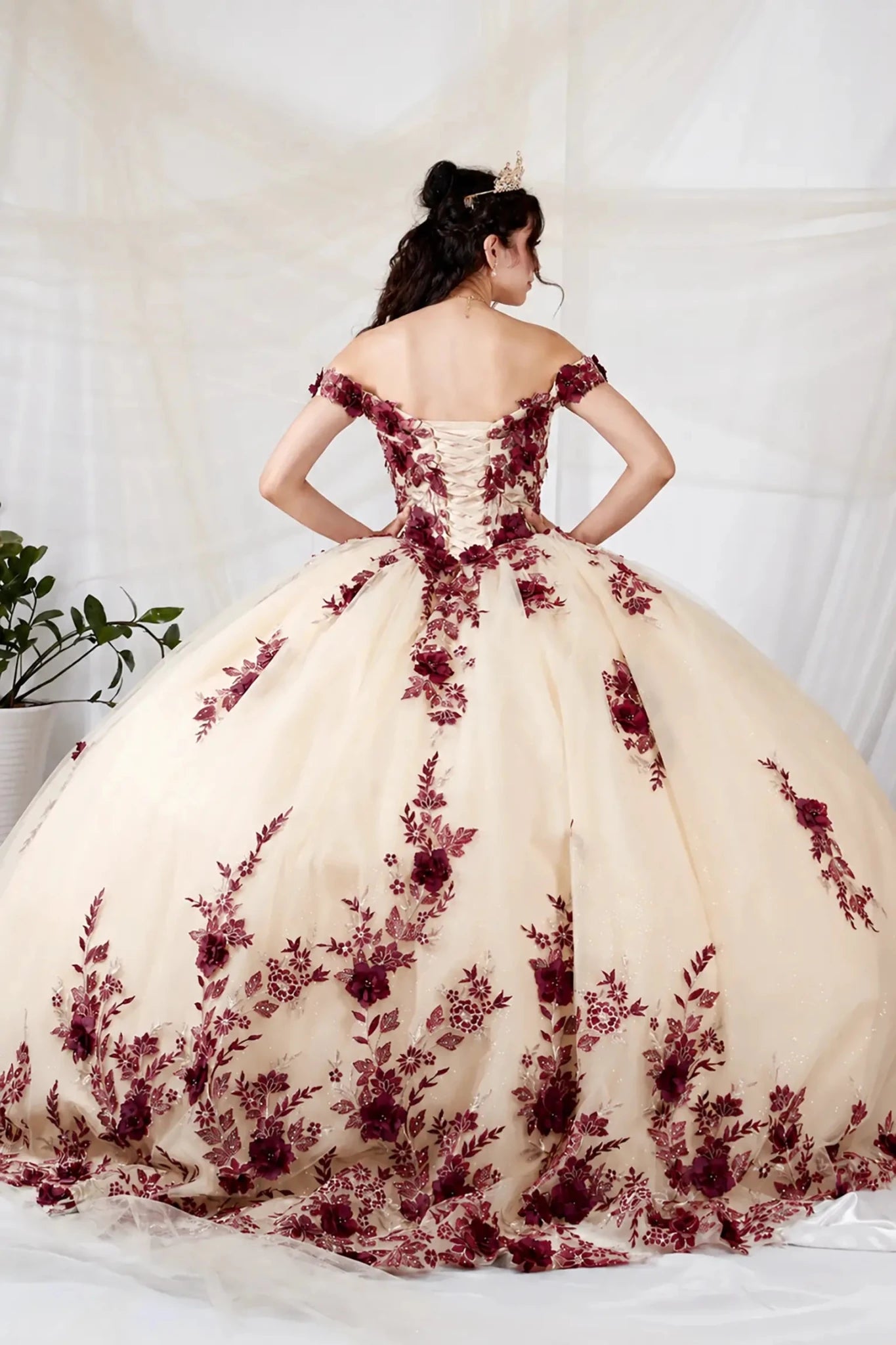 champagne quinceanera ball gown with deep burgundy floral lace appliques and lace up back