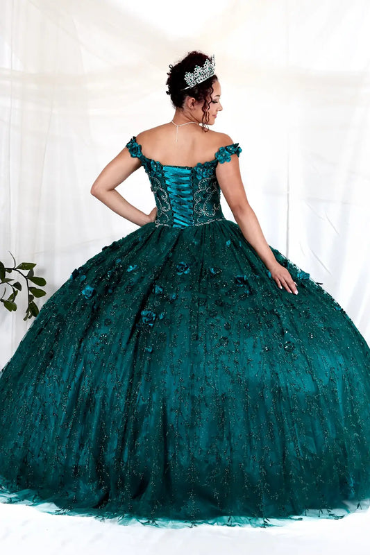 Back-Facing of a woman wearing Emerald formal gown featuring long trailing tail layered skirt and structured back design