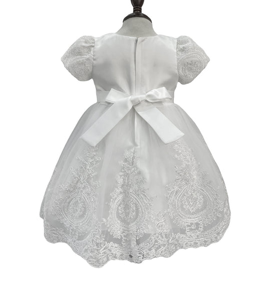 White lace dress with a bow on a mannequin against a white background